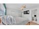 Comfortable main bedroom with ceiling fan, large windows, and bathroom access at 118 Lake Sears Dr, Winter Haven, FL 33880