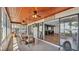 Bright sunroom with wood ceiling, tile floor, dining table, and lake view at 118 Lake Sears Dr, Winter Haven, FL 33880