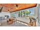 Bright sunroom with wood ceiling, tile floor, and multiple windows showcasing lake view at 118 Lake Sears Dr, Winter Haven, FL 33880