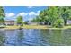 Waterfront home features well-maintained lawn extending to lakefront with scenic water views and lush greenery at 118 Lake Sears Dr, Winter Haven, FL 33880
