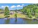 The waterfront home boasts a well-manicured lawn extending to the water's edge and views of the lake at 118 Lake Sears Dr, Winter Haven, FL 33880