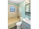 Bathroom featuring a tub-shower, toilet, and a vanity with modern lighting at 120 Bolender Rd, Auburndale, FL 33823