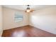 Bedroom with a window, light-colored walls, wooden-look flooring, and ceiling fan at 120 Bolender Rd, Auburndale, FL 33823
