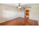 Bedroom with ceiling fan, light-colored walls, and wooden-look flooring at 120 Bolender Rd, Auburndale, FL 33823