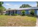 Delightful single story home with a metal roof and a screened porch, set on a lush green lawn at 120 Bolender Rd, Auburndale, FL 33823