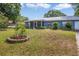 Inviting single story home with a metal roof, a screened porch, and a well-manicured lawn at 120 Bolender Rd, Auburndale, FL 33823