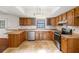 Traditional-style kitchen with wooden cabinets, stainless steel appliances, and tile flooring at 120 Bolender Rd, Auburndale, FL 33823
