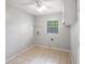 Laundry room with tile flooring, utility sink, and window at 120 Bolender Rd, Auburndale, FL 33823