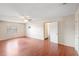 Spacious living room with hardwood floors, neutral walls, ceiling fan, and natural light at 120 Bolender Rd, Auburndale, FL 33823