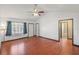 Bright living room featuring hardwood floors, high ceilings, and a calming view of the bathroom at 120 Bolender Rd, Auburndale, FL 33823