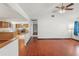 Spacious living area showcasing hardwood floors, high ceilings, and seamless flow to the kitchen at 120 Bolender Rd, Auburndale, FL 33823