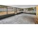 Enclosed sunroom with a concrete floor offering views of the expansive backyard at 120 Bolender Rd, Auburndale, FL 33823