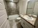 Updated bathroom with a bathtub and shower combo with tiled surround, and granite countertop vanity at 1251 Dosseywood Ln, Lakeland, FL 33811