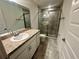 Bathroom features a granite countertop vanity and a glass-enclosed shower with tile surround at 1251 Dosseywood Ln, Lakeland, FL 33811