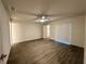 Bedroom featuring laminate floors, sliding glass doors to the backyard, and standard closet at 1251 Dosseywood Ln, Lakeland, FL 33811
