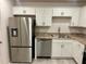 Well-appointed kitchen with stainless steel refrigerator, dishwasher, and updated countertops at 1251 Dosseywood Ln, Lakeland, FL 33811