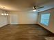 Open concept living room with updated light fixtures, laminate flooring, and natural lighting at 1251 Dosseywood Ln, Lakeland, FL 33811
