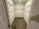 Walk-in closet with wire shelving, offering ample storage with modern, wood-look flooring at 1251 Dosseywood Ln, Lakeland, FL 33811