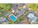 Aerial view of a home with an in-ground pool surrounded by well-maintained landscaping and a privacy fence at 1421 Camphor Dr, Lakeland, FL 33803