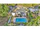 Aerial view of home with swimming pool, patio area, and fenced backyard at 1421 Camphor Dr, Lakeland, FL 33803