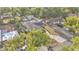 Aerial view of a charming home featuring a spacious yard, mature trees, and inviting pool area at 1421 Camphor Dr, Lakeland, FL 33803