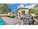 Inviting backyard with brick-paved patio, barbecue and refreshing pool view from home exterior at 1421 Camphor Dr, Lakeland, FL 33803