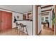 Cozy bar area featuring seating, a brick backsplash, and hardwood floors at 1421 Camphor Dr, Lakeland, FL 33803