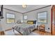 Comfortable bedroom featuring three windows, wood floors, and a neutral color scheme at 1421 Camphor Dr, Lakeland, FL 33803