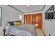 Bedroom with laminate floors, a closet, a television, and natural lighting through the window at 1421 Camphor Dr, Lakeland, FL 33803