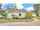 Exterior view of the home showcasing the garden and brick walkway to the front door at 1421 Camphor Dr, Lakeland, FL 33803
