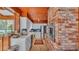 Spacious kitchen boasts white cabinets, stainless steel appliances, and a brick oven feature wall at 1421 Camphor Dr, Lakeland, FL 33803