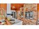 Cozy kitchen with white countertops, stainless steel appliances and brick oven feature wall, with wood ceilings at 1421 Camphor Dr, Lakeland, FL 33803