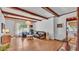 Cozy living room with exposed wood beams, laminate floors and bright light from the exterior window at 1421 Camphor Dr, Lakeland, FL 33803
