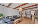 Comfortable living area with exposed beams, wood-look floors, and an open layout into an adjacent room at 1421 Camphor Dr, Lakeland, FL 33803