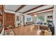 Charming living room featuring beamed ceilings, wood-look floors, and natural light from the windows at 1421 Camphor Dr, Lakeland, FL 33803