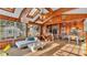 Bright living space with wood ceilings and walls, featuring brick oven and cozy seating area at 1421 Camphor Dr, Lakeland, FL 33803