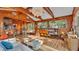 Open living space with wood-paneled walls and white ceiling beams, with an abundance of natural light at 1421 Camphor Dr, Lakeland, FL 33803