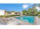 Relaxing backyard featuring an in-ground pool, lounge chairs and manicured landscaping at 1421 Camphor Dr, Lakeland, FL 33803