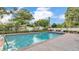 Private pool area featuring mature landscaping and a brick-paved pool deck, ideal for relaxation at 1421 Camphor Dr, Lakeland, FL 33803