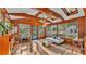 Bright sunroom with wood-paneled walls and beamed ceiling, leading to a pool through a glass door at 1421 Camphor Dr, Lakeland, FL 33803