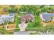 Breathtaking aerial view of a house with a screened pool, a well-kept lawn, and a paver driveway at 146 Woodside Dr, Lakeland, FL 33813