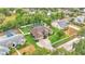 An aerial view of a well-maintained home and yard, complete with screened pool, and stone-paved driveway at 146 Woodside Dr, Lakeland, FL 33813