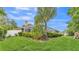 Expansive backyard showcasing a screened-in pool, lush landscaping, and ample green space at 146 Woodside Dr, Lakeland, FL 33813