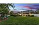 Expansive backyard with a screened-in pool, lush greenery, and a playful area for  at 146 Woodside Dr, Lakeland, FL 33813
