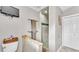 This bathroom features a toilet, towel rack, and enclosed shower with updated fixtures at 146 Woodside Dr, Lakeland, FL 33813