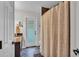 Bathroom featuring dark marble countertops and a decorative shower curtain at 146 Woodside Dr, Lakeland, FL 33813