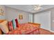 Bedroom with red-patterned bedding and white closet doors at 146 Woodside Dr, Lakeland, FL 33813