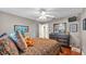 Well-lit bedroom with a ceiling fan, dresser, and a doorway leading to another room at 146 Woodside Dr, Lakeland, FL 33813