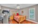 Bedroom featuring hardwood floors and a decorative bed with a ceiling fan at 146 Woodside Dr, Lakeland, FL 33813