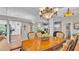 Open-concept dining area with a view of the kitchen and living room, with a chandelier at 146 Woodside Dr, Lakeland, FL 33813